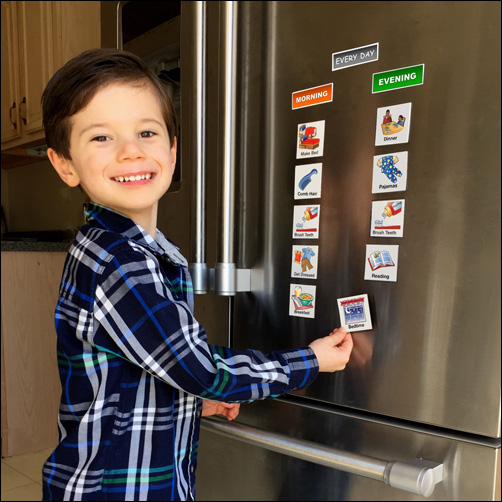 child using schKIDules on their fridge