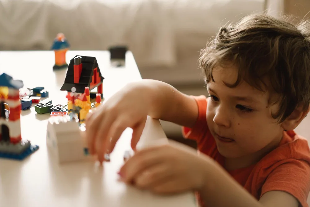 child building with lego 